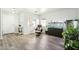 Living area with hardwood floors and a brown leather chair at 28125 N Silver Ln, San Tan Valley, AZ 85143