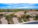 A high-angle aerial showcases this solar-paneled desert home with manicured landscaping and a beautiful community at 28247 N 128Th Dr, Peoria, AZ 85383