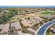 Expansive aerial view of home in desert community near golf course with solar panels on tile roof at 28247 N 128Th Dr, Peoria, AZ 85383