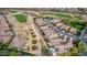 Scenic aerial view of homes, street, and golf course with greens in a beautiful neighborhood at 28247 N 128Th Dr, Peoria, AZ 85383