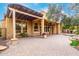 Backyard oasis features covered patio, an outdoor kitchen, and serene rock water feature at 28247 N 128Th Dr, Peoria, AZ 85383