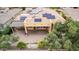 Aerial view of backyard with large covered patio, pavers, pond, and efficient solar panel array at 28247 N 128Th Dr, Peoria, AZ 85383