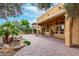 Expansive covered patio and outdoor entertaining space, complete with a built-in grill and water feature at 28247 N 128Th Dr, Peoria, AZ 85383