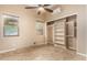 An empty bedroom with lots of natural light coming through windows, ceiling fan, and an open closet at 28247 N 128Th Dr, Peoria, AZ 85383