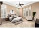 Bright bedroom with tray ceiling, plantation shutters, neutral walls, and neutral decor at 28247 N 128Th Dr, Peoria, AZ 85383