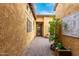 Enclosed courtyard featuring decorative wall art and a brick-paved path at 28247 N 128Th Dr, Peoria, AZ 85383