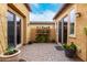 Private courtyard with sliding doors, potted plants, and a charming flower display at 28247 N 128Th Dr, Peoria, AZ 85383