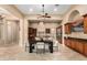 Dining area featuring stylish seating, elegant lighting, and views into the gourmet kitchen at 28247 N 128Th Dr, Peoria, AZ 85383