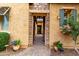 Open front doorway framed by stone, leading to a cozy interior hallway at 28247 N 128Th Dr, Peoria, AZ 85383