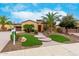 Charming home featuring a well-manicured front yard, mature trees, and inviting curb appeal at 28247 N 128Th Dr, Peoria, AZ 85383