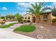 Beautiful front yard with lush landscaping, stone accents, and a charming entryway at 28247 N 128Th Dr, Peoria, AZ 85383