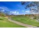 Expansive golf course view showcases lush green fairways and mature trees against a backdrop of distant mountains at 28247 N 128Th Dr, Peoria, AZ 85383