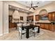 Gourmet kitchen with stainless steel appliances and a modern dark wood dining table at 28247 N 128Th Dr, Peoria, AZ 85383