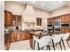 Gourmet kitchen with custom cabinets, stainless steel appliances, a center island, and elegant countertops at 28247 N 128Th Dr, Peoria, AZ 85383