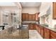 Well-equipped kitchen with granite countertops and dark wood cabinetry at 28247 N 128Th Dr, Peoria, AZ 85383