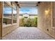 Cozy outdoor patio with stone flooring and a view of the landscaped backyard at 28247 N 128Th Dr, Peoria, AZ 85383