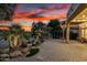 Beautiful backyard water feature, lush greenery, and covered patio space, ideal for relaxation at 28247 N 128Th Dr, Peoria, AZ 85383