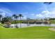 Scenic water feature with decorative rockwork, small falls, and lush green landscaping offers a tranquil community view at 28247 N 128Th Dr, Peoria, AZ 85383