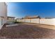 Spacious backyard with gravel and a covered patio, bordered by a block wall at 3258 E Dover St, Mesa, AZ 85213