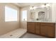 Elegant bathroom with double vanity, large mirror, and walk-in shower at 3258 E Dover St, Mesa, AZ 85213