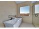 Clean bathroom with soaking tub and glass enclosure at 34045 N Borgata Trl, Queen Creek, AZ 85144