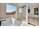 Spa-like bathroom with soaking tub and glass shower at 34045 N Borgata Trl, Queen Creek, AZ 85144