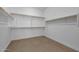 Large walk-in closet with wood shelving and rod at 34045 N Borgata Trl, Queen Creek, AZ 85144