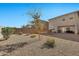 Large backyard with gravel, raised garden bed, and patio at 35298 W San Ildefanso Ave, Maricopa, AZ 85138