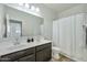 Bathroom boasts a double vanity and shower/tub combo at 35298 W San Ildefanso Ave, Maricopa, AZ 85138