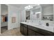 Bathroom with double vanity, dark cabinets, and a large mirror at 35298 W San Ildefanso Ave, Maricopa, AZ 85138