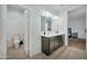 Double vanity bathroom with dark wood cabinets and a separate toilet area at 35298 W San Ildefanso Ave, Maricopa, AZ 85138