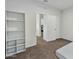 Spacious bedroom with built-in shelving and carpet flooring at 35298 W San Ildefanso Ave, Maricopa, AZ 85138