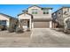 Two-story house with a two-car garage and desert landscaping at 35298 W San Ildefanso Ave, Maricopa, AZ 85138