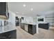 Modern kitchen island with granite countertops and stainless steel appliances at 35298 W San Ildefanso Ave, Maricopa, AZ 85138