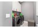 Convenient laundry room with washer, dryer, and overhead cabinets at 3923 W Hayduk Rd, Laveen, AZ 85339