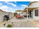 Patio with seating, hot tub, grill, and umbrella at 40136 N Costa Del Sol Dr, San Tan Valley, AZ 85140