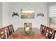 Bright dining area with wood table and chairs, complemented by artwork and decor at 40136 N Costa Del Sol Dr, San Tan Valley, AZ 85140