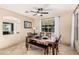 Cozy dining room with a wooden table, bench, and a modern ceiling fan at 42531 W Chisholm Dr, Maricopa, AZ 85138