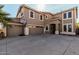 Lovely curb appeal with a wide driveway and a three-car garage at 42531 W Chisholm Dr, Maricopa, AZ 85138