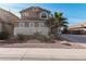 Charming two-story home with a desert-landscaped front yard and lovely architectural details at 42531 W Chisholm Dr, Maricopa, AZ 85138