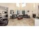 Spacious living area featuring high ceilings, a fireplace, and large windows at 42531 W Chisholm Dr, Maricopa, AZ 85138