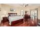 Hardwood flooring and ensuite bathroom access highlight the bright and airy primary bedroom at 42531 W Chisholm Dr, Maricopa, AZ 85138