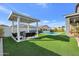 Expansive backyard with a pergola, artificial turf, and a refreshing pool at 4752 S Orbit Ave, Mesa, AZ 85212