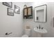 Small bathroom with pedestal sink and toilet at 4752 S Orbit Ave, Mesa, AZ 85212