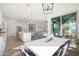 Bright dining room with white table and chairs, adjacent to kitchen at 4752 S Orbit Ave, Mesa, AZ 85212