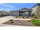 Single-story home with gray siding, stone accents, and a two-car garage at 4752 S Orbit Ave, Mesa, AZ 85212