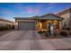 Charming single-story home with neutral gray exterior, brick driveway, manicured landscape, and covered porch at 4752 S Orbit Ave, Mesa, AZ 85212