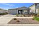 Single-story home with gray siding, stone accents, and a two-car garage at 4752 S Orbit Ave, Mesa, AZ 85212