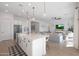 Modern white kitchen with large island and stainless steel appliances at 4752 S Orbit Ave, Mesa, AZ 85212