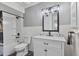 Well-lit bathroom with a tub and shower combination, a large vanity with marble countertop and modern fixtures at 5045 W Mescal St, Glendale, AZ 85304